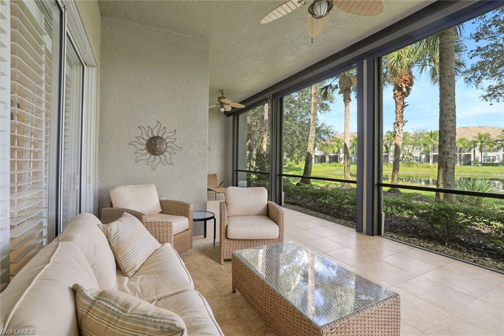Sunroom / solarium featuring a ceiling fan, outdoor lounge area, and a water view