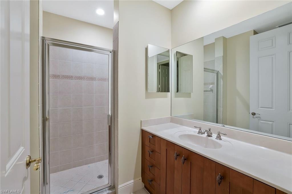 Bathroom with a stall shower and vanity