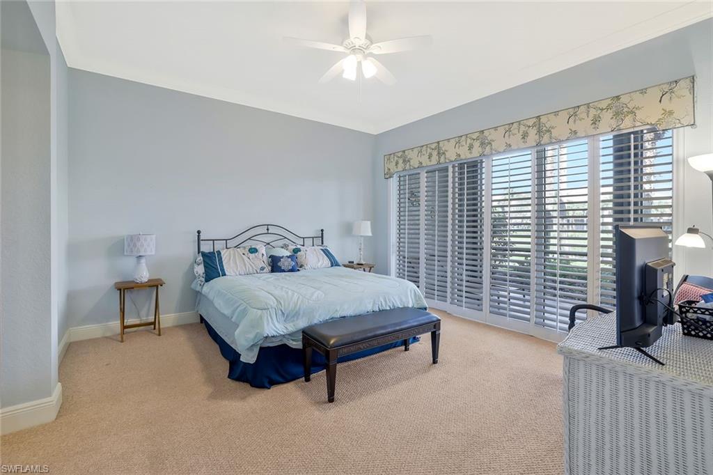 Bedroom with carpet flooring, ornamental molding, and ceiling fan