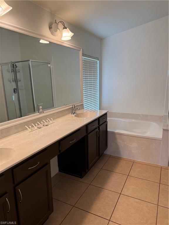 Bathroom featuring a double vanity with an integrated sink, dark wood-finish cabinetry, and a large framed mirror