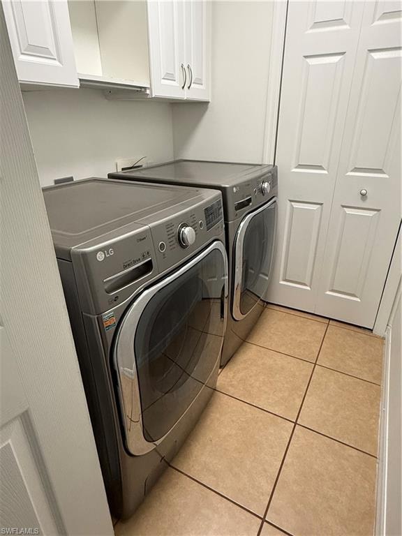 Laundry area featuring ceramic tile flooring and shaker-style cabinetry with brushed nickel hardware