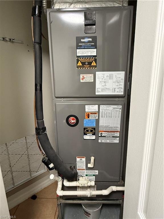 Gray central HVAC unit featuring insulated lines and white PVC piping