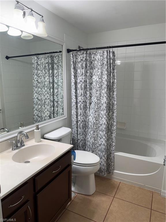 Bathroom featuring a vanity with dark wood-finish cabinetry, a white countertop with an integrated sink, and a chrome faucet