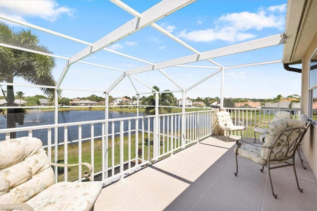 Balcony featuring a sunroom and a water view