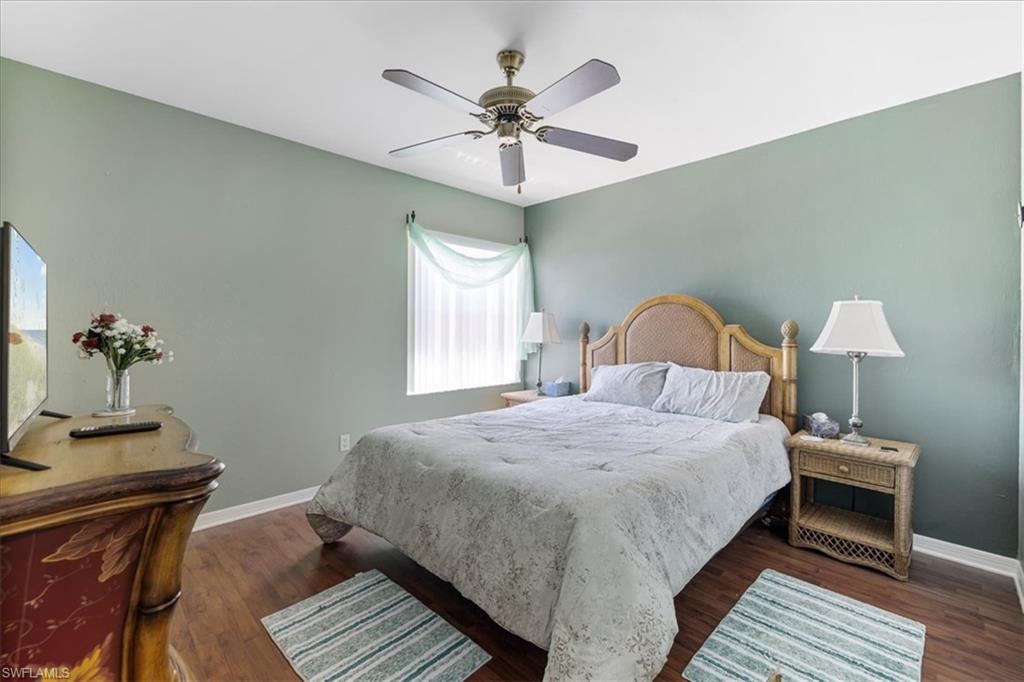 Bedroom with baseboards, ceiling fan, and wood finished floors