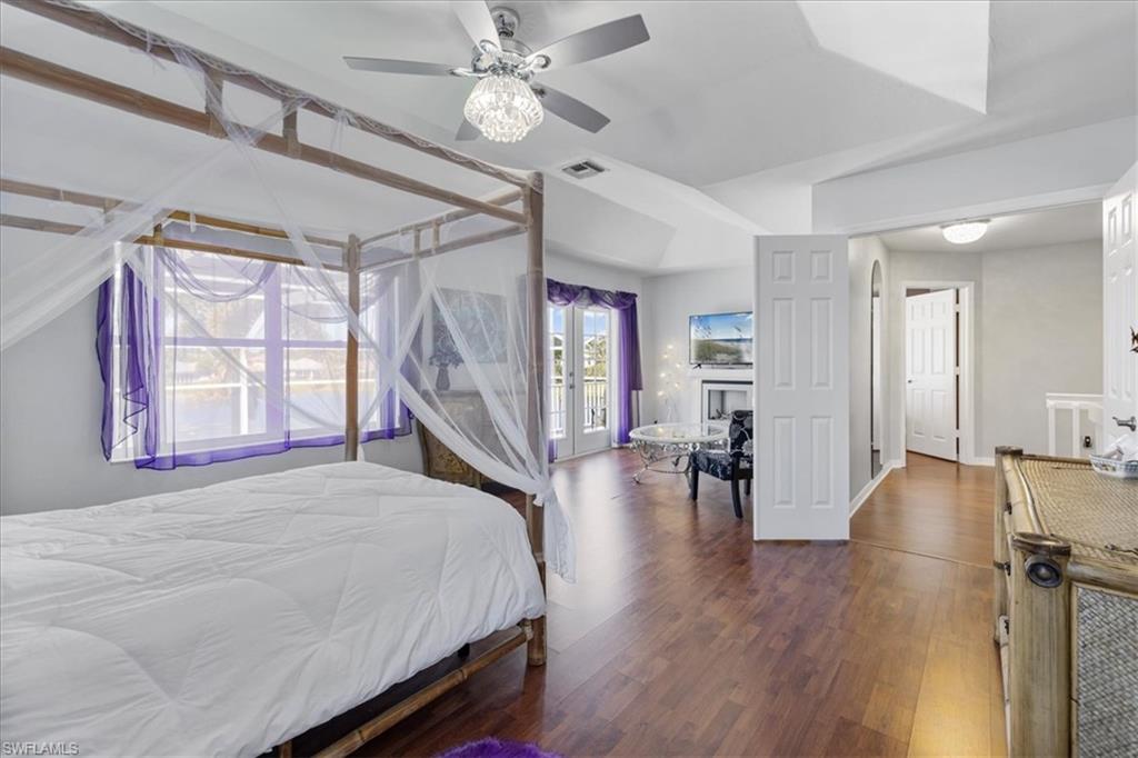 Bedroom featuring visible vents, wood finished floors, and a ceiling fan