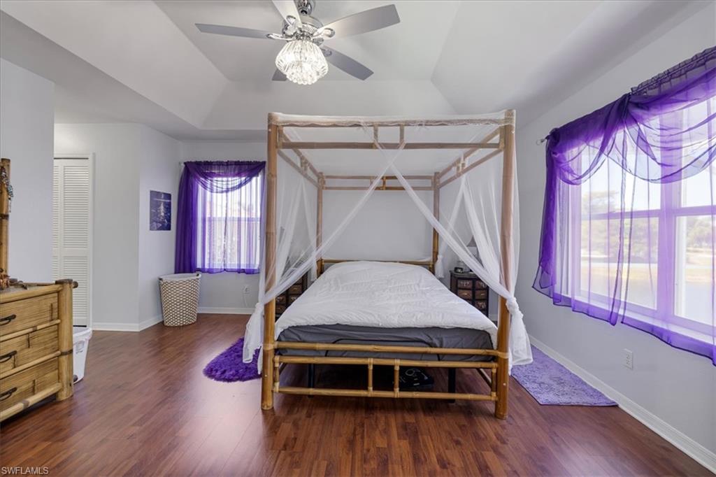 Bedroom with baseboards, ceiling fan, and wood finished floors