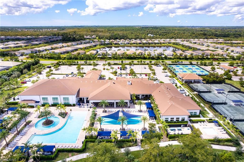 Extensive community clubhouse featuring multiple swimming pools, sports courts, and ample parking