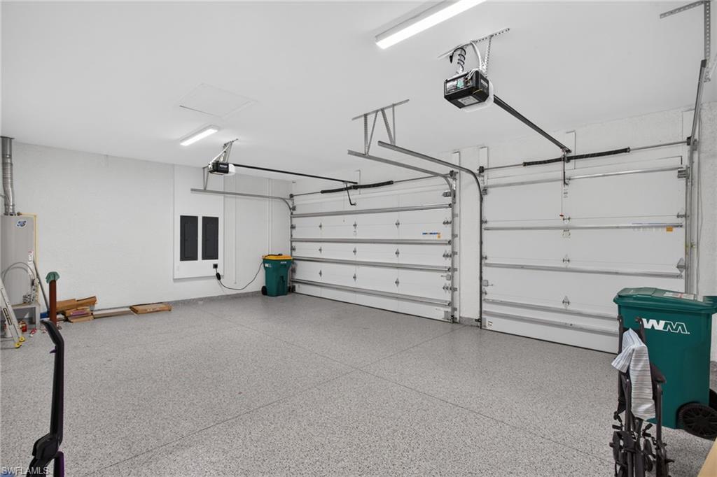 Two-car garage featuring automatic garage door openers and epoxy flooring