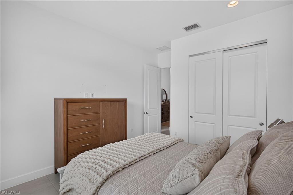 Recessed ceiling lighting illuminates a spacious room featuring white walls, baseboards, and a neutral flooring