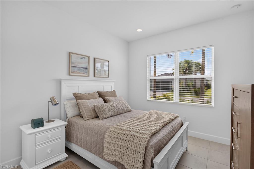Bedroom featuring light-toned tile flooring and white walls