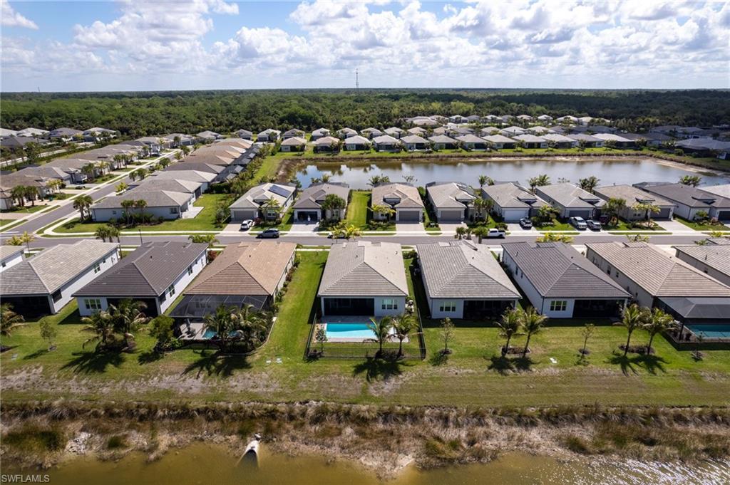 Aerial perspective of a residential development featuring single-story homes with individual swimming pools and screened enclosures