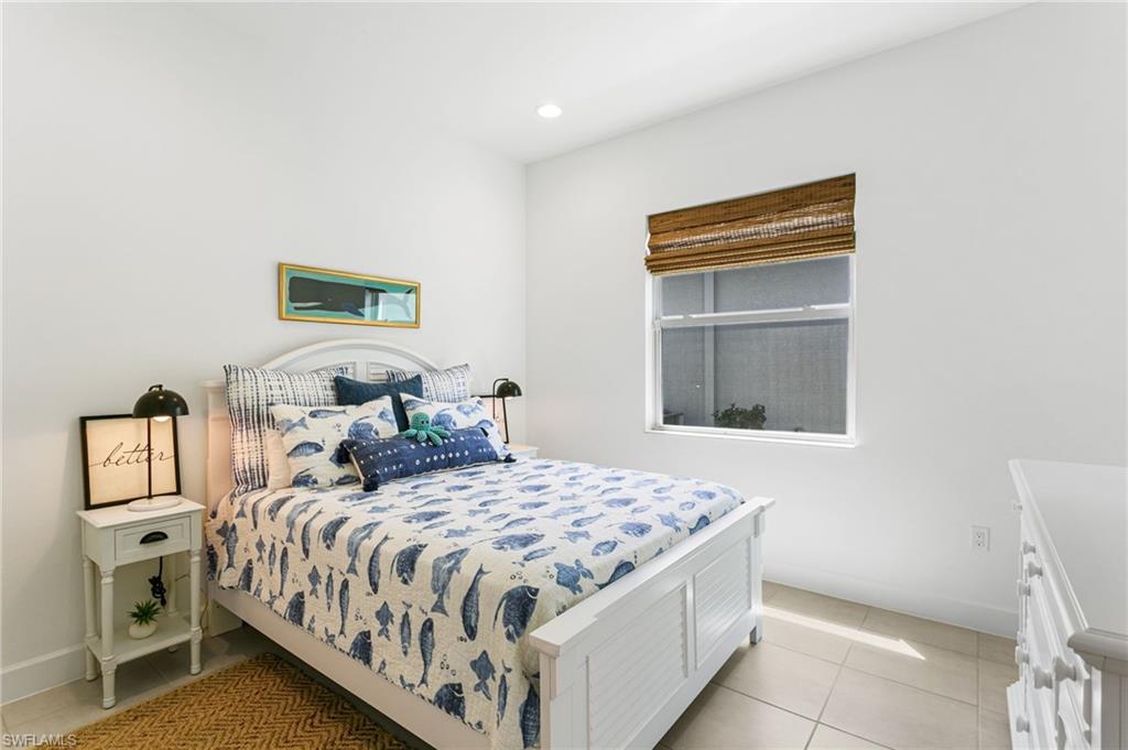 Recessed lighting illuminating a bedroom featuring light tile flooring and white walls