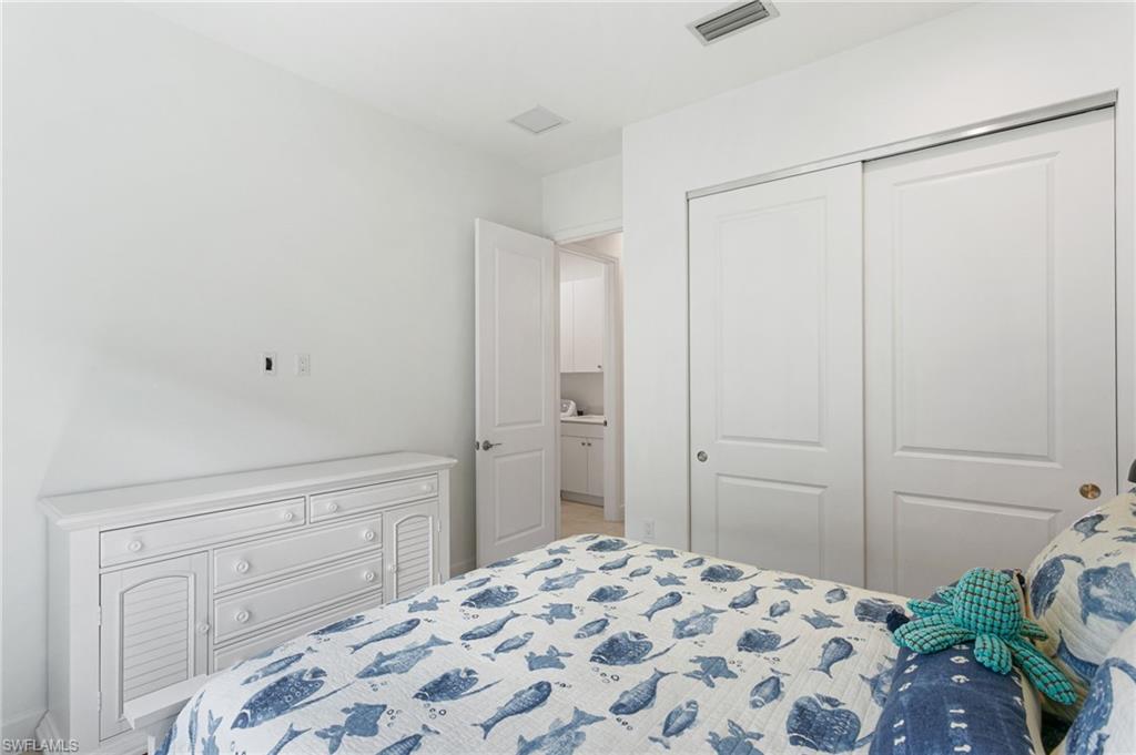 Interior room featuring white walls, a white paneled sliding closet door, and a white interior door