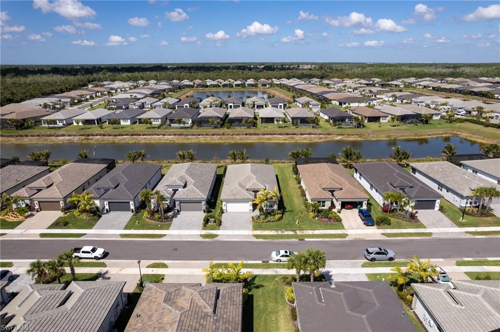 Aerial perspective of a developed residential community featuring multiple modern single-story homes