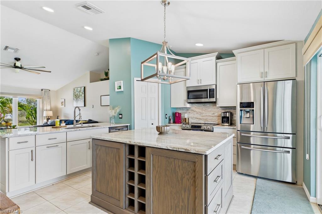 WELCOME to your dream kitchen! A perfect place to gather around the large kitchen island and bar!