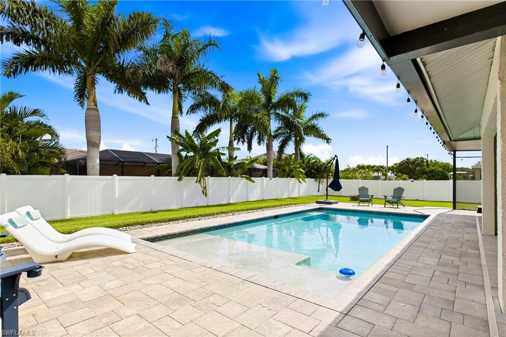 Back view of the pool and patio - check out the large sun shelf and bubbler!