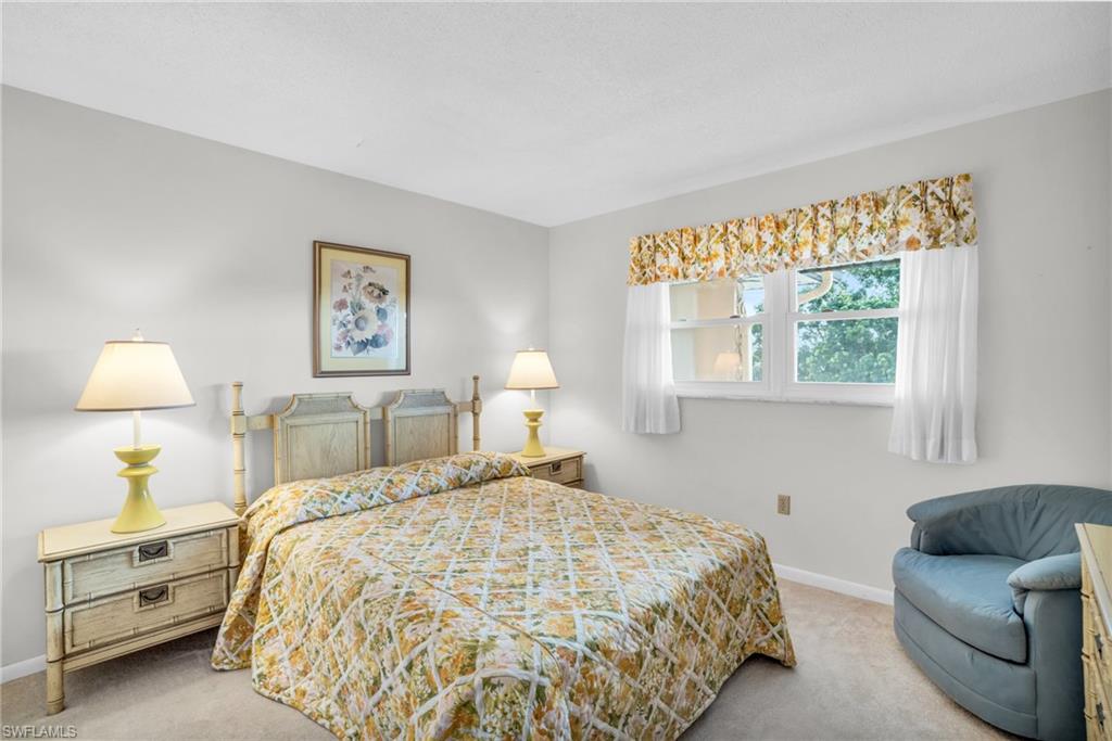 GUEST BEDROOM SUITE WITH POCKET DOOR AND NEWER IMPACT WINDOW..