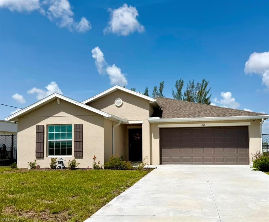 Single-story residence featuring a two-car garage, concrete driveway, and a stucco exterior