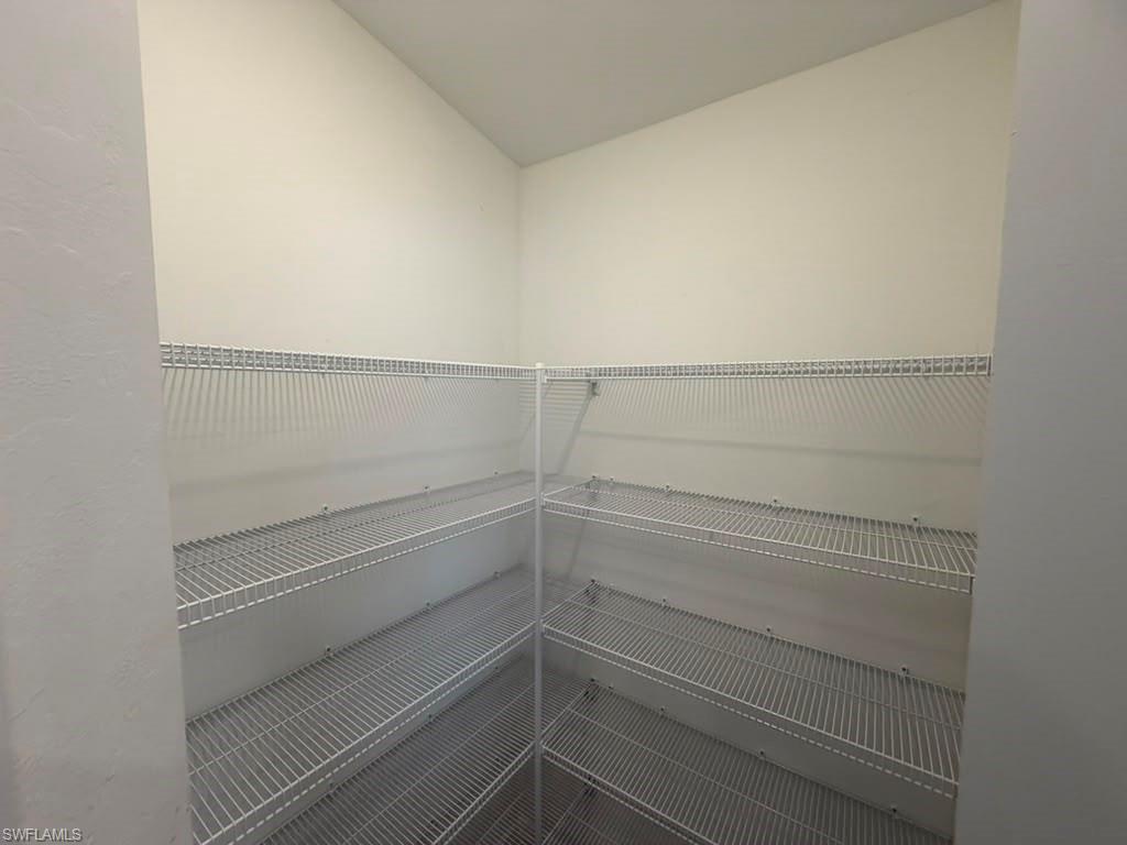 Walk-in pantry featuring white wire shelving