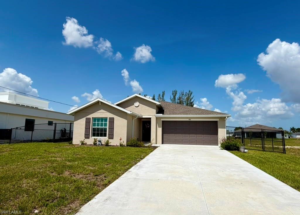 Single-story residence featuring a stucco exterior and an attached garage with a brown door