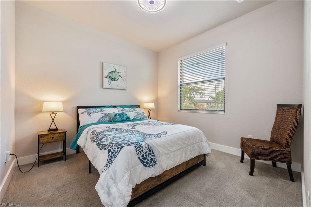 Carpeted bedroom with a window featuring horizontal blinds, recessed lighting, and a ceiling fan
