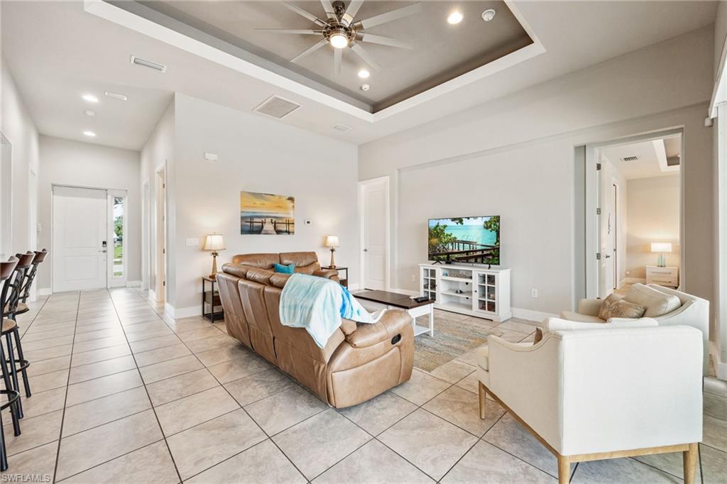 Open-concept living area featuring large format tile flooring throughout