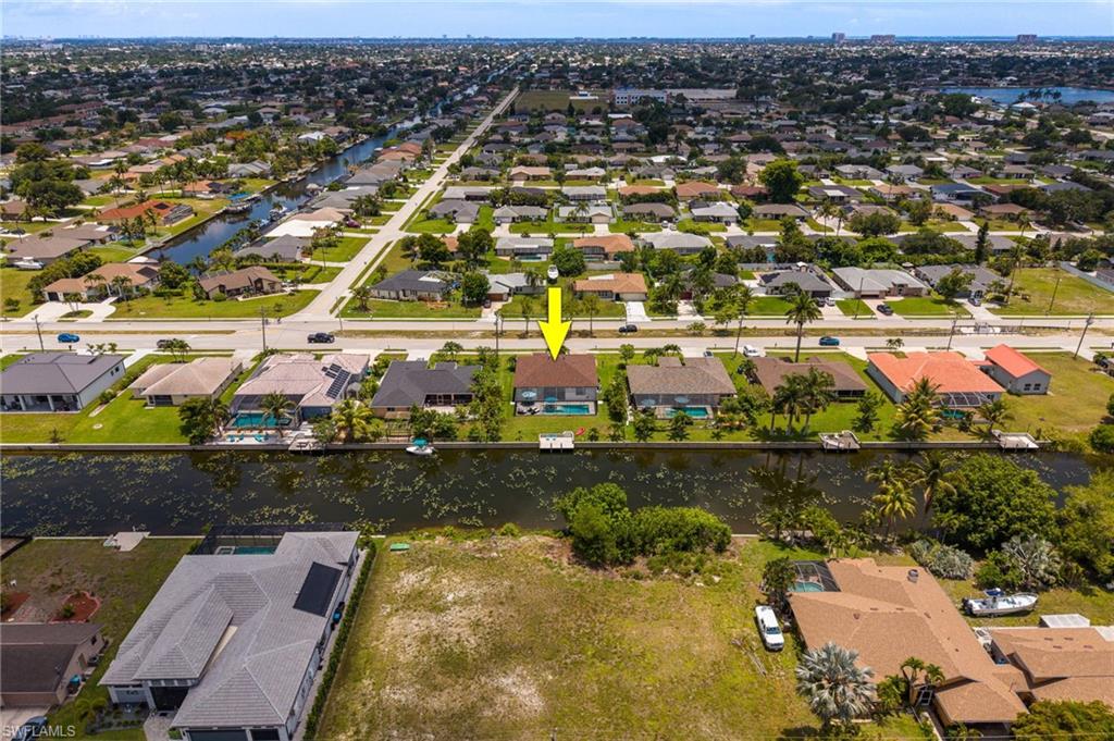 Aerial perspective showcasing a residential property with a private pool