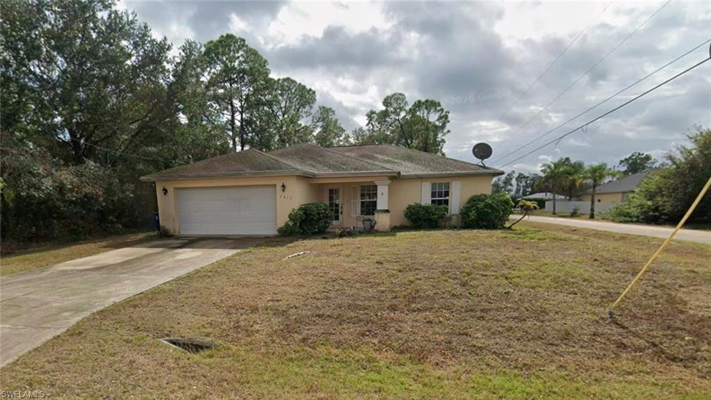 Single-story residence featuring a two-car garage and a paved driveway