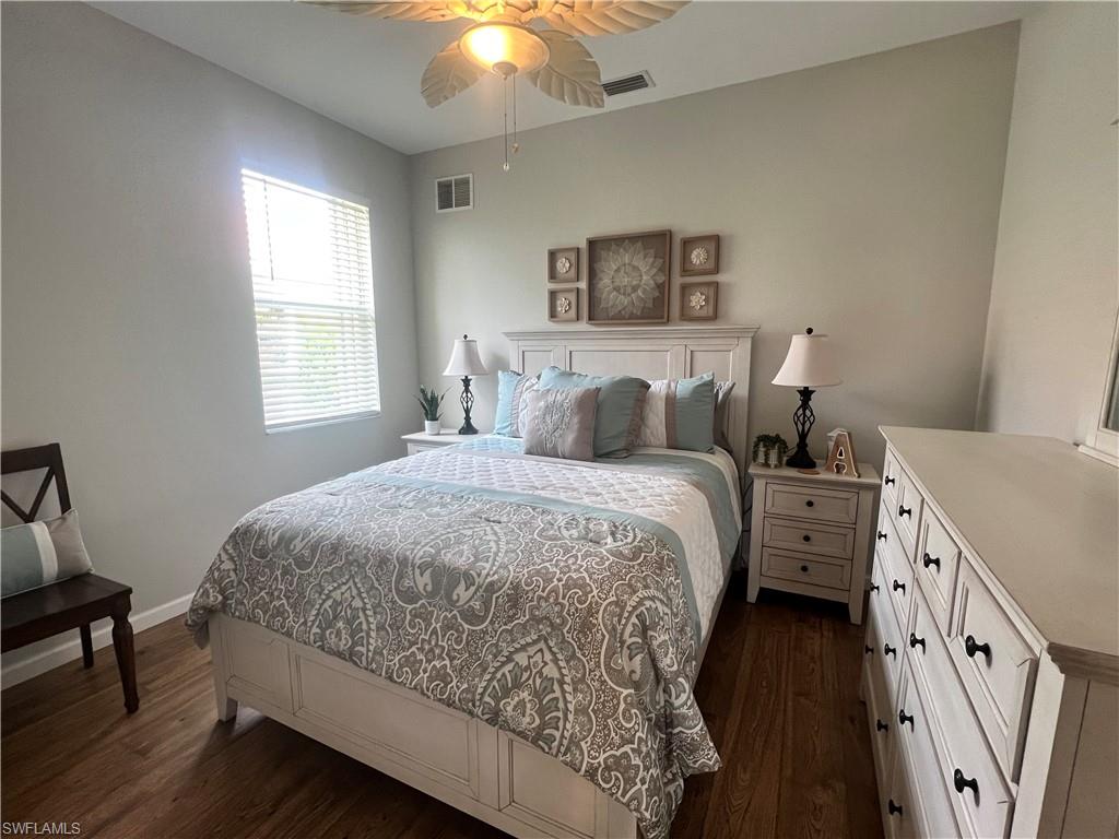 Guest Bedroom featuring ceiling fan and dark hardwood / wood-style floors