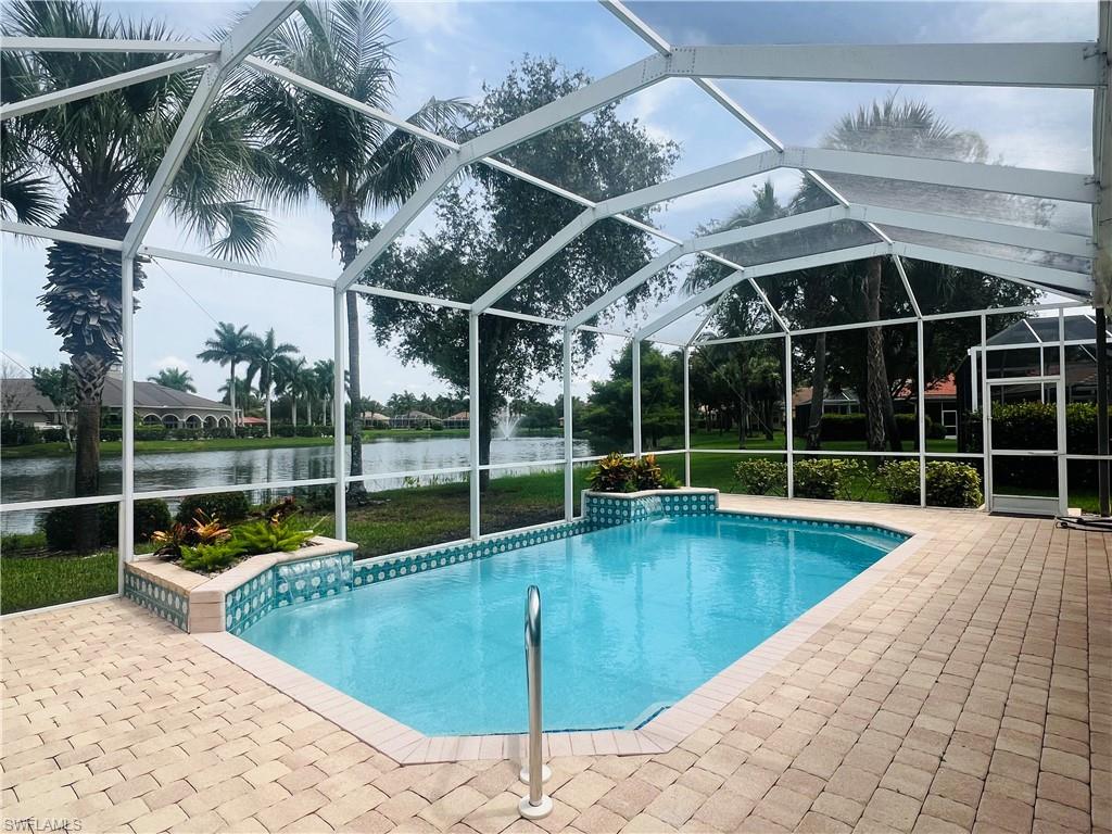 View of pool with a patio and screen enclosure