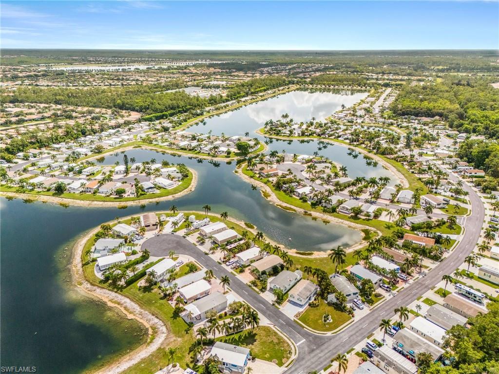 Aerial perspective showcasing a residential community with winding roads and numerous homes.