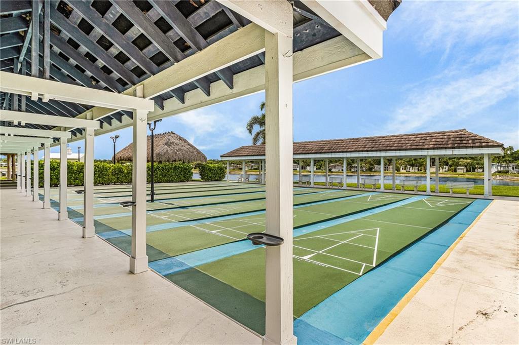 Shuffleboard courts featuring multiple playing surfaces and a covered walkway.