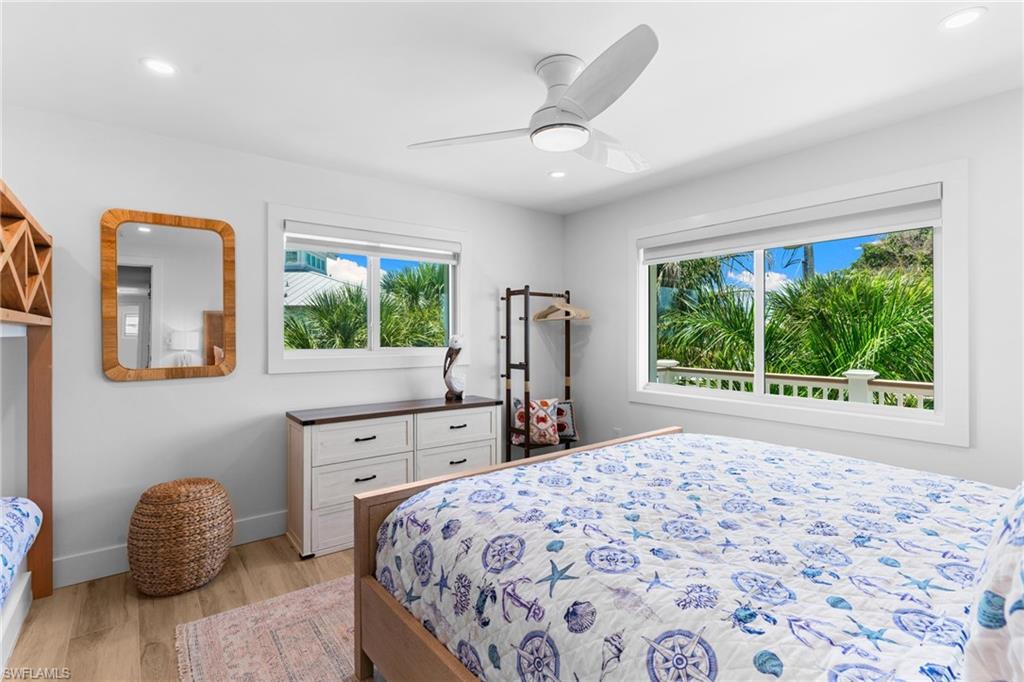 Bright interior room featuring wood-finish flooring, recessed lighting, and a contemporary ceiling fan