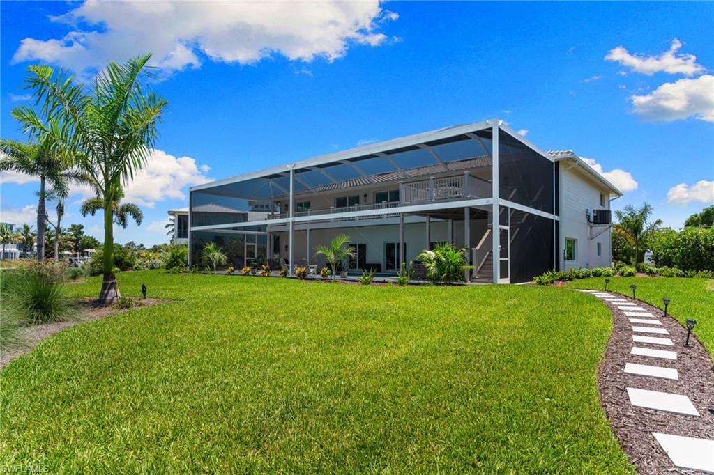 Expansive screened lanai across two levels with outdoor patio space