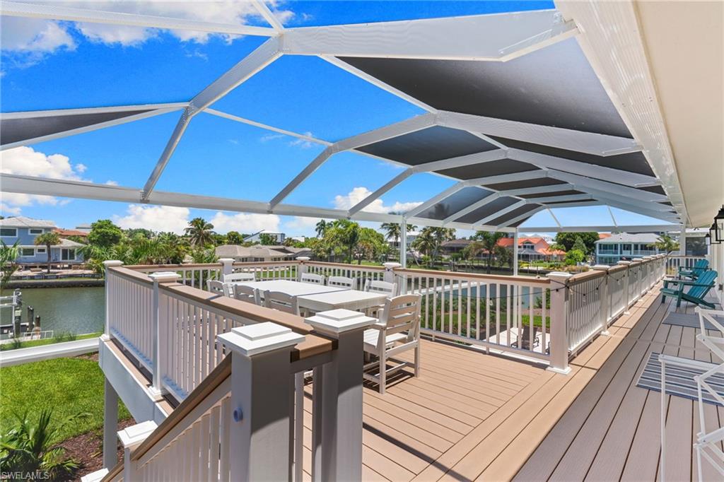 Expansive screened deck featuring composite decking and a white railing system