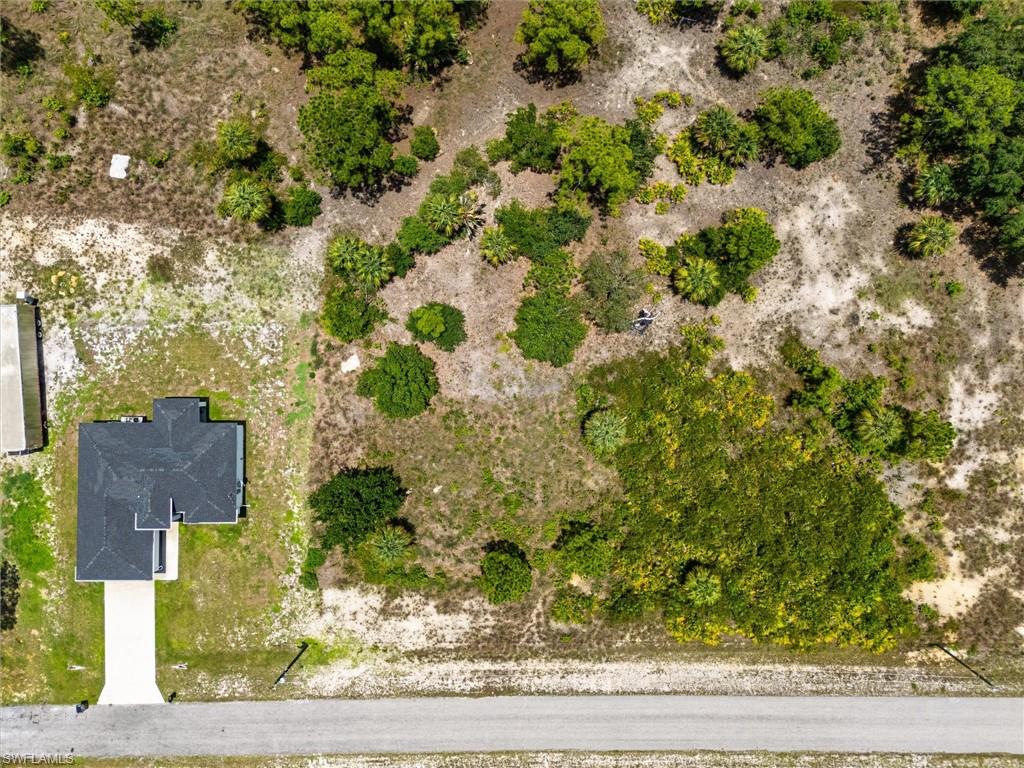 Aerial perspective showcasing a single-story residence with a dark shingle roof