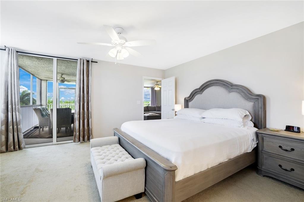 Bedroom with light colored carpet, access to outside, and multiple windows