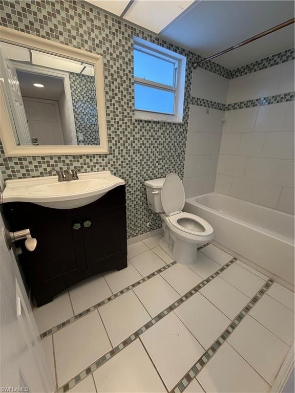 Bathroom featuring a dark wood-finish vanity with an integrated sink, mosaic tile accent walls, a bathtub with white subway tile surround, and white floor tiles with mosaic inlay strips