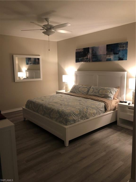 Neutral-toned walls complement wood-finish flooring in this bedroom
