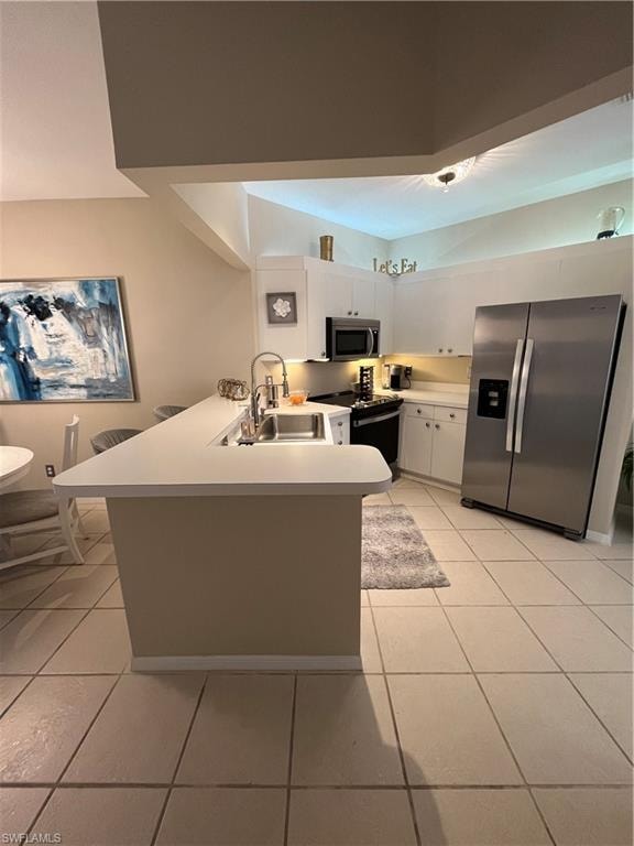 Kitchen featuring light-toned tile flooring and white cabinetry