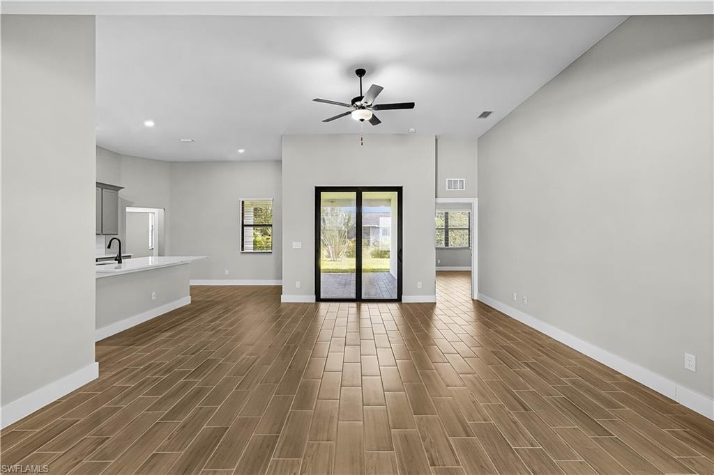 Unfurnished living room featuring recessed lighting, wood finish floors, and ceiling fan