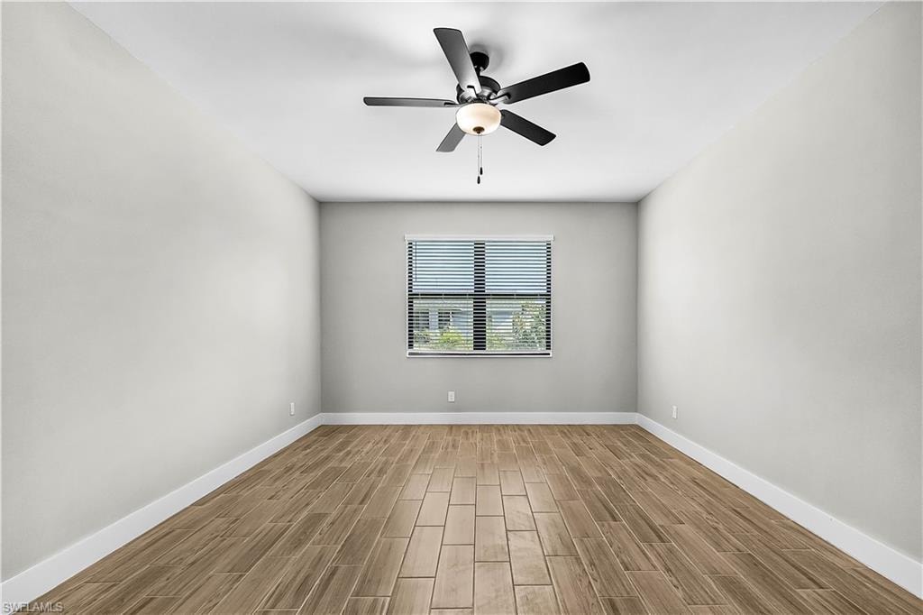Unfurnished room featuring wood finish floors and a ceiling fan