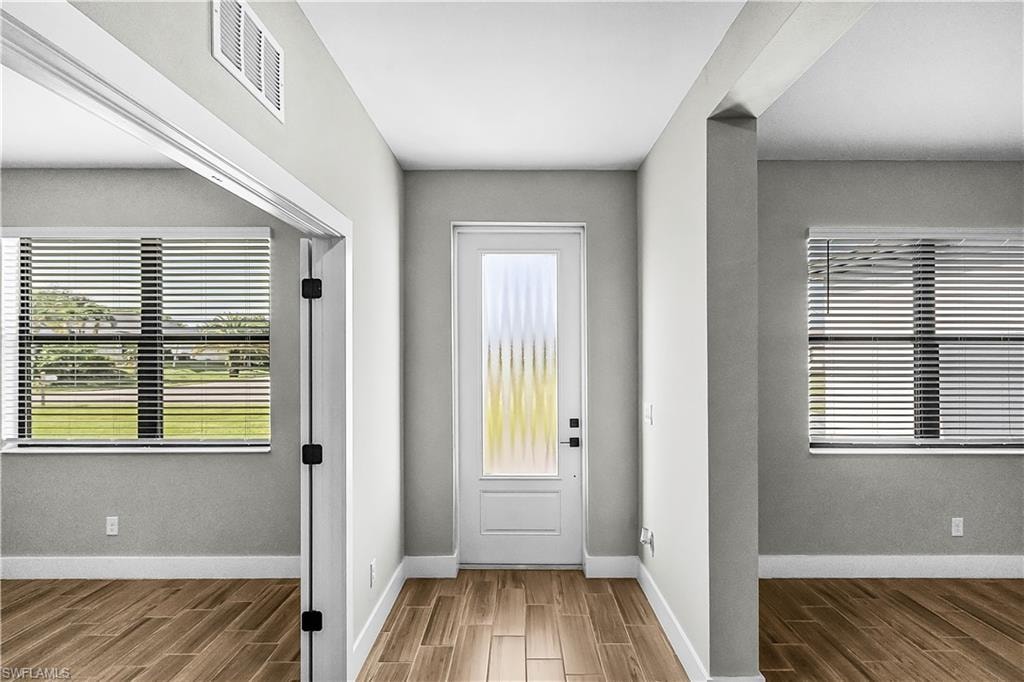 Entryway featuring wood tiled floors and baseboards
