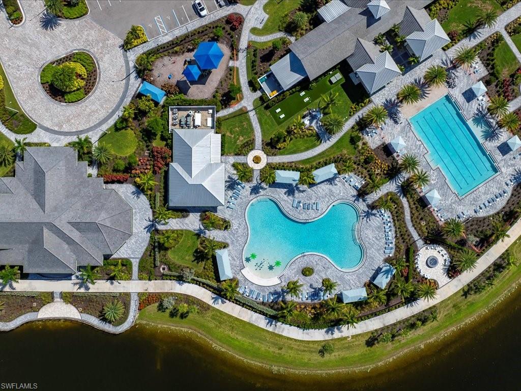Aerial view showcasing two community pools, a rectangular lap pool, and a freeform leisure pool