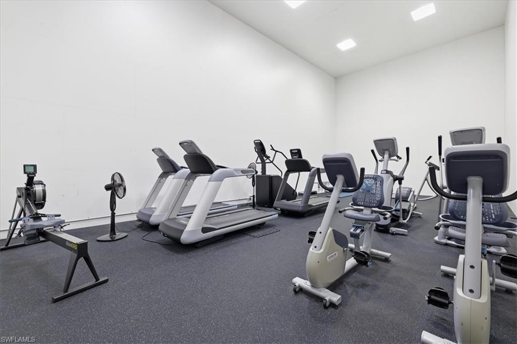 Dedicated fitness room featuring recessed lighting, a durable rubberized floor, and white walls