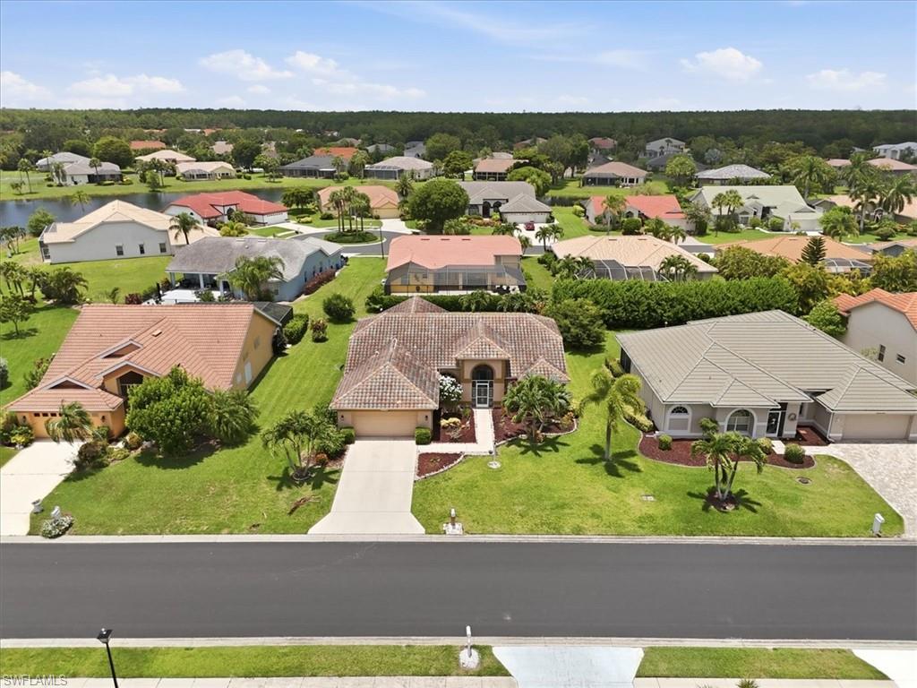 Suburban neighborhood featuring a variety of single-story homes with tile roofs and well-maintained lawns