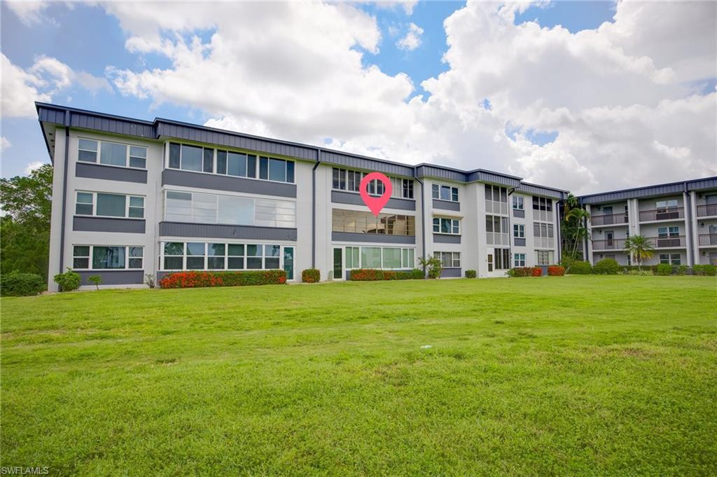 Low-rise multi-family building featuring a light gray and dark gray facade with multiple window styles