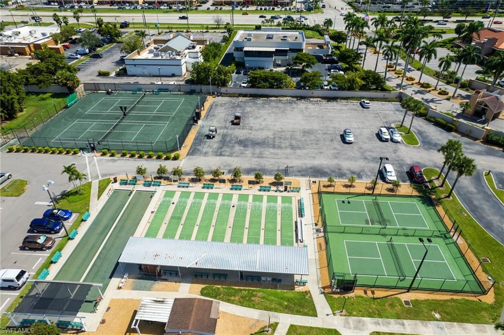 Recreational amenities featuring multiple tennis courts, pickleball, bocce ball courts, and a covered pavilion