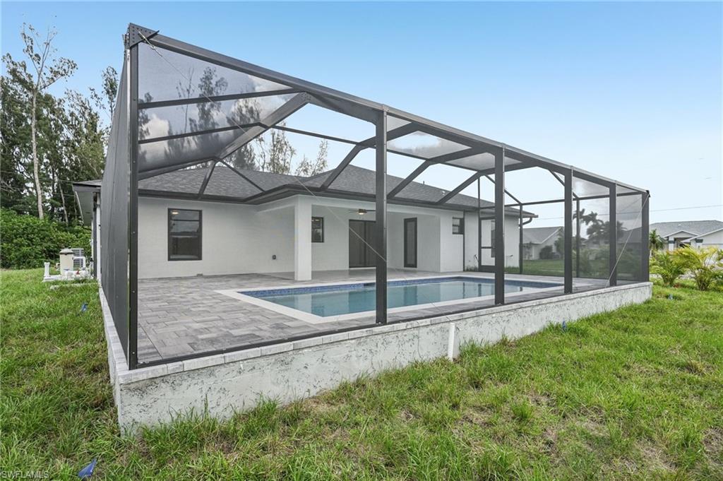 Modern stucco exterior with dark trim accents, a prominent front entry, a two-car garage, and a concrete driveway